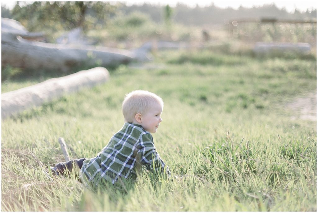 Family-portrait-session-image-of-boy-in-field-on-Camano-Island-photographed-during-the-golden-hour