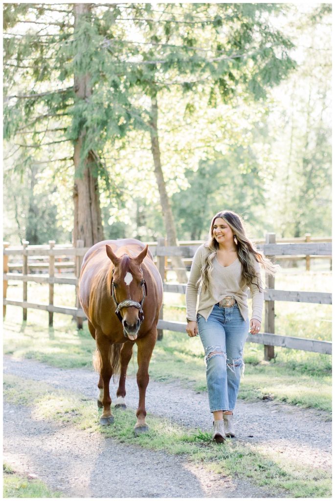 Girl-walking-with-her-horse-laughing