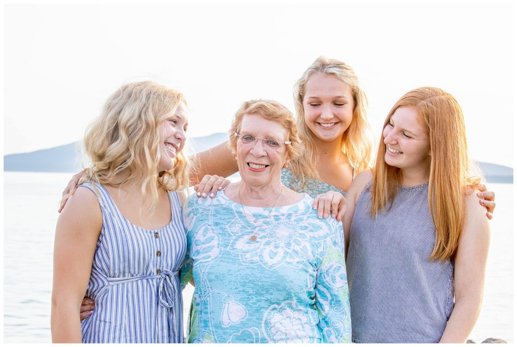 Fall family photos with blue color palette with grandmother and grandchildren on beach