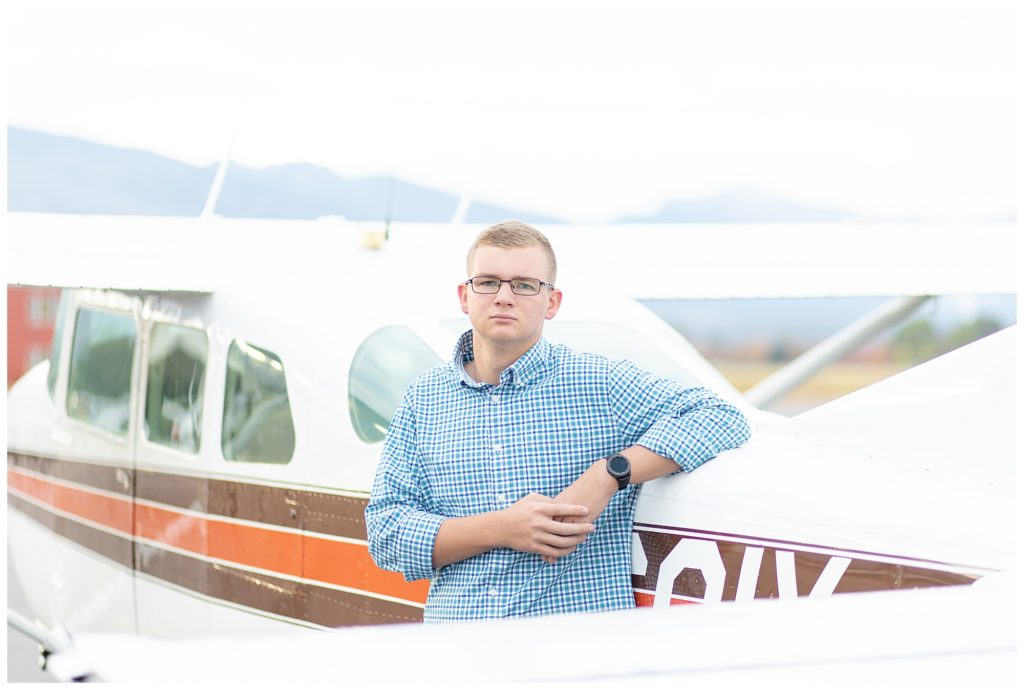 senior guy standing with plane at airport in Hamilton, Montana
