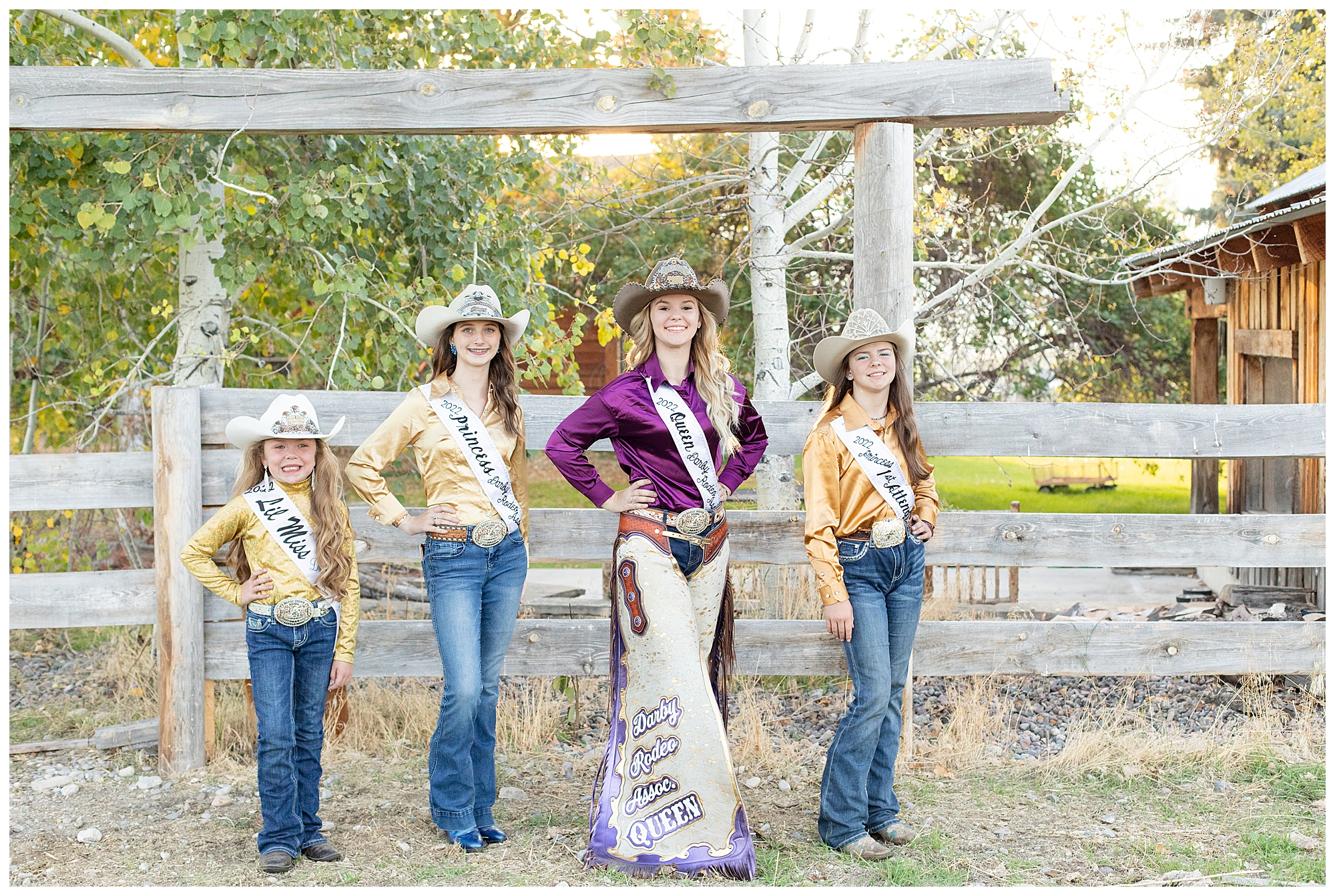 Darby Rodeo Association Royalty girls standing in front of barn