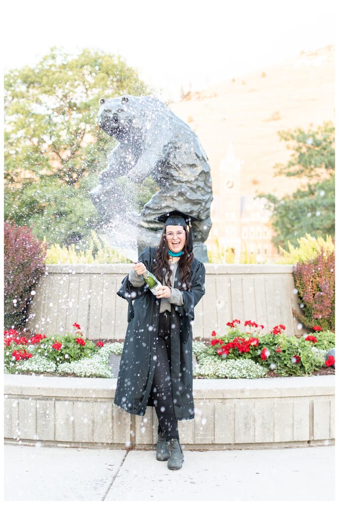University of Montana grad photos with senior in front of Grizzly Statue by Missoula senior photographer Katherine Schot Photography