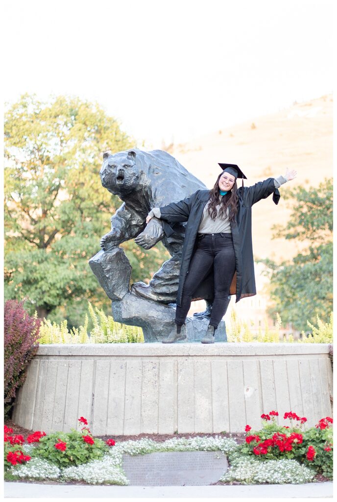 Grad photo with Grizzly Statue on University of Montana campus in Missoula, MT
