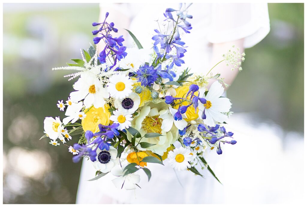 Blue, yellow and white florals by Bleeding Heart Flower Farm for Montana luxury ranch elopement