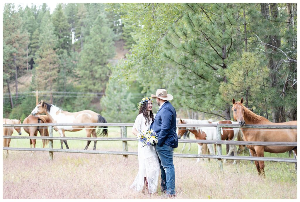 Montana luxury ranch elopement in Darby Montana at Triple Creek Ranch with horses in field