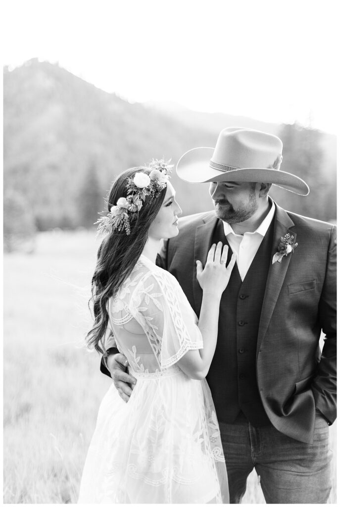 Montana luxury ranch elopement with timeless style of couple smiling at each other in pasture