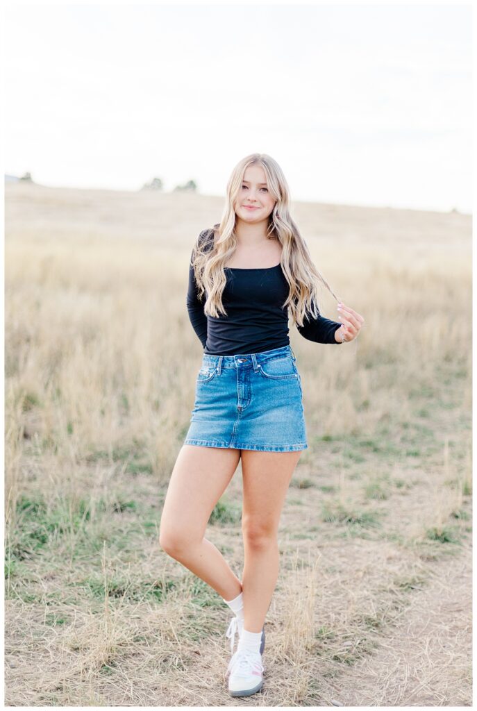 Missoula senior photos of Hellgate High School senior standing in field