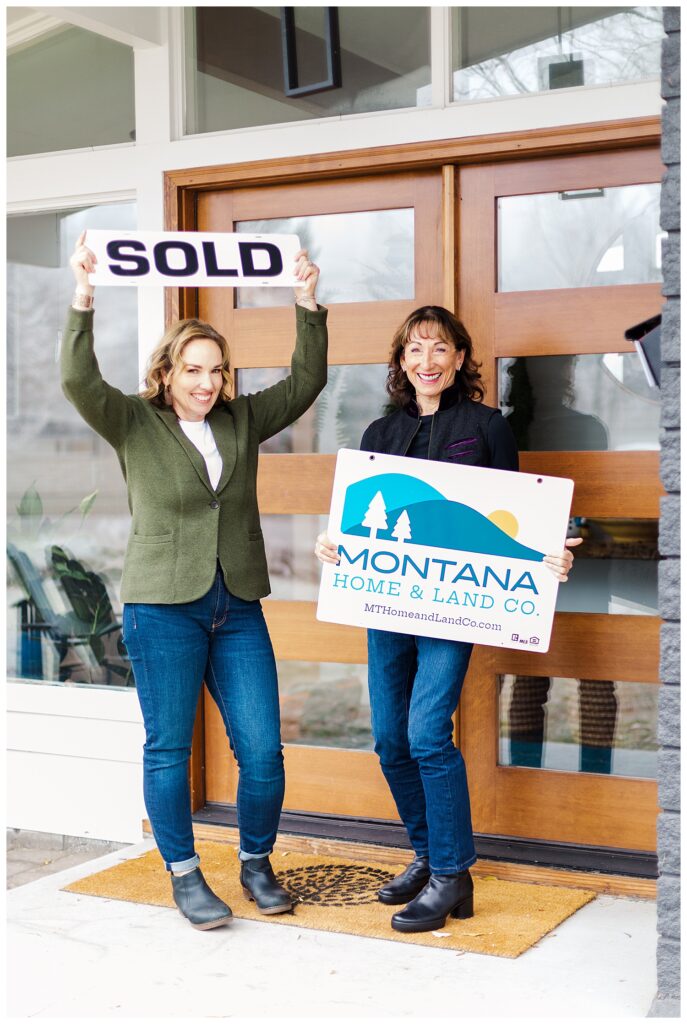 Missoula realtors holding sold sign and Montana Land & Home Co sign