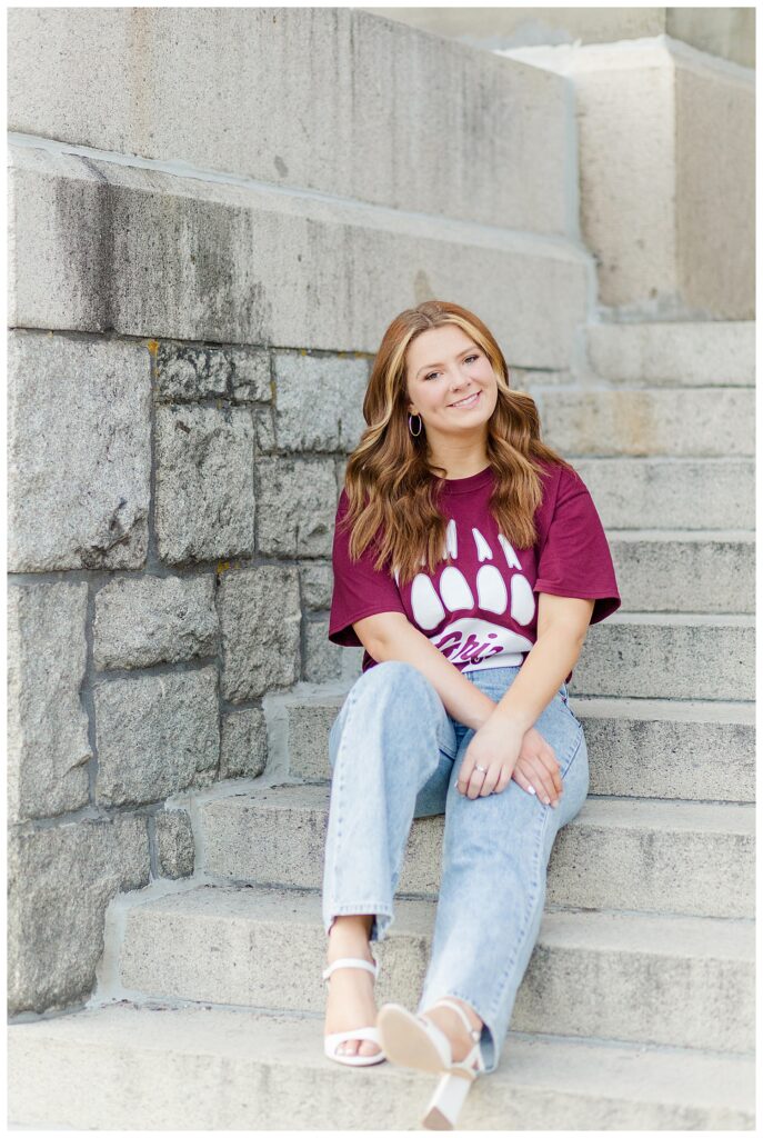 Graduation photos with Knoxville senior photographer with senior girl sitting on steps wearing college tee